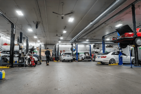 German Auto Repair LLC auto workshop with vehicles on lifts, technicians performing inspections, Rockville, Maryland