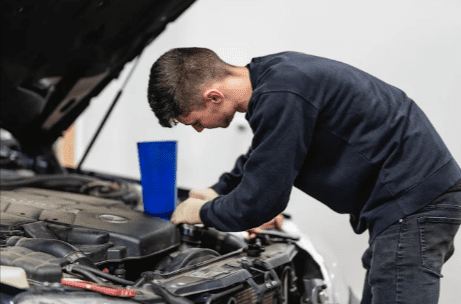 Technician performing BMW engine repair in the workshop for Rockville BMW service, German Auto Repair LLC